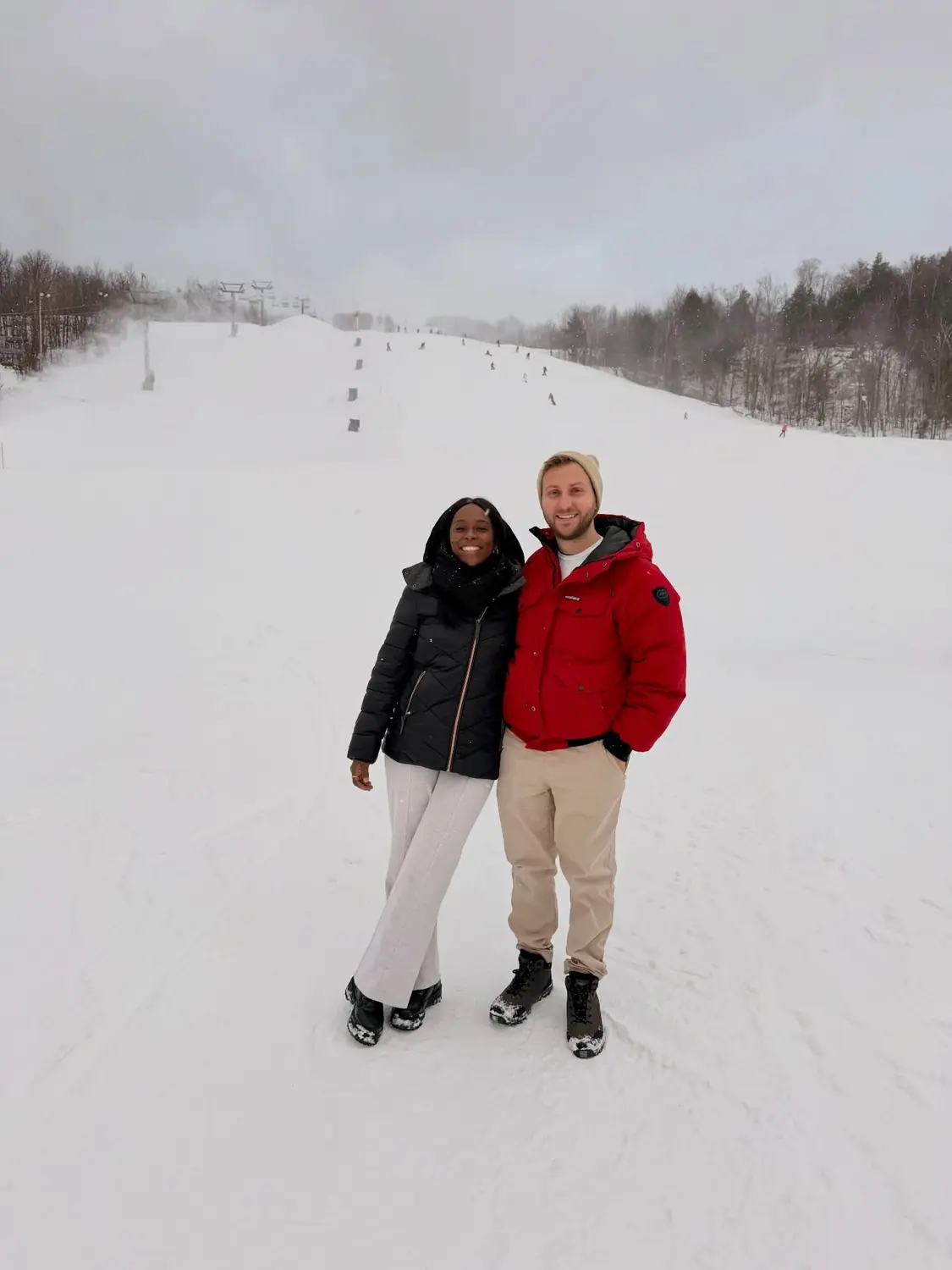 Us standing at the bottom of a ski slope at Mont Tremblant