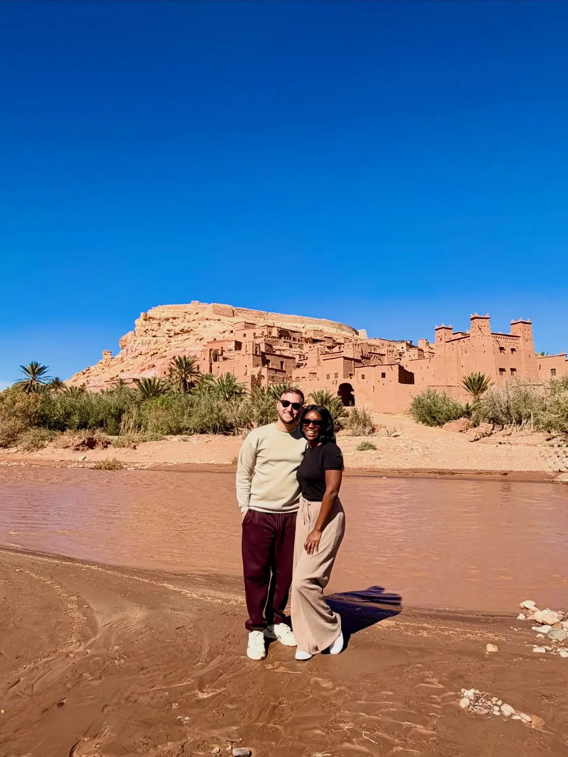 Us by the river below the mud-brick ksar of Aït Ben Haddou