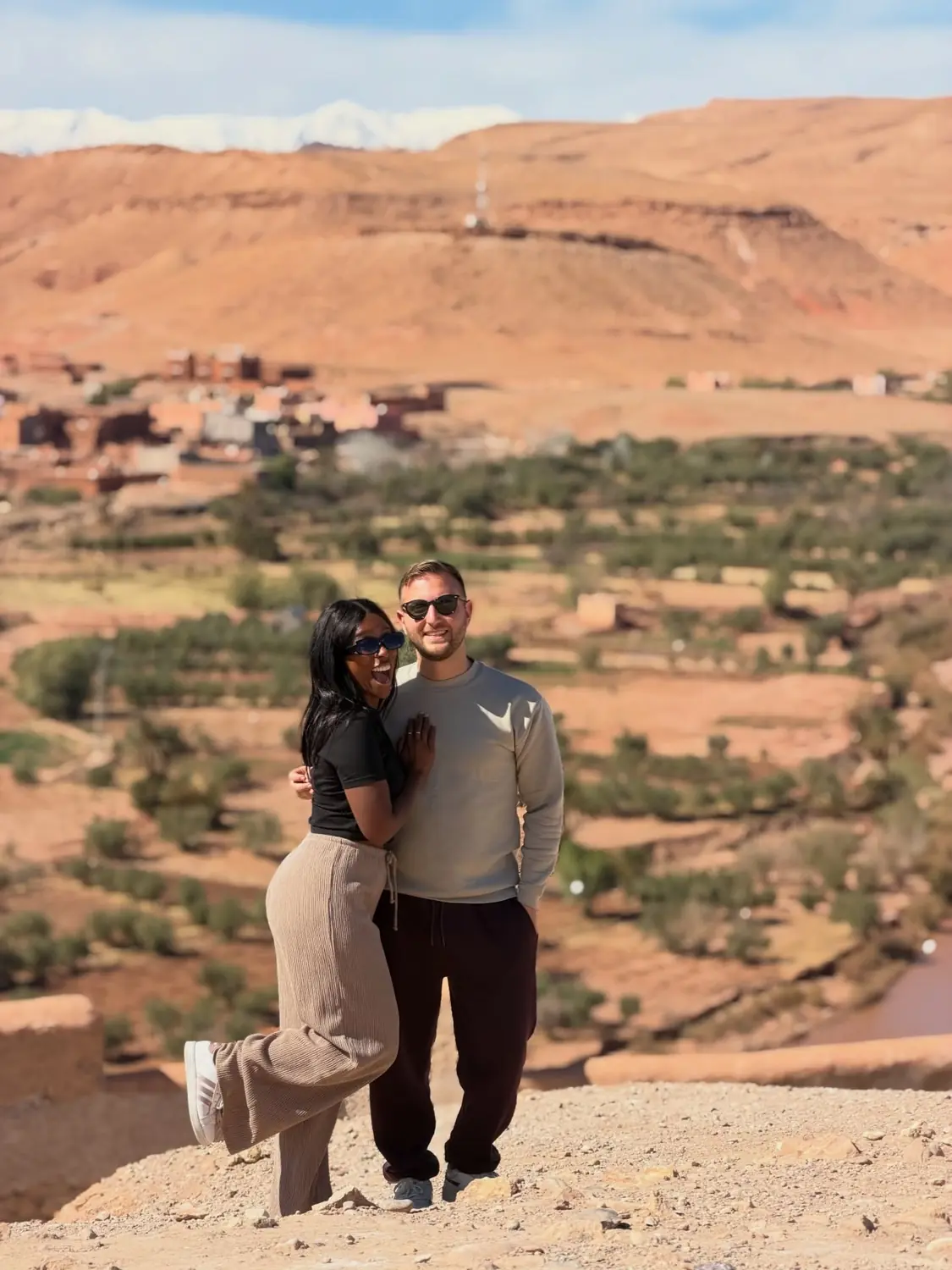 Us at a viewpoint over a green valley and the Atlas
