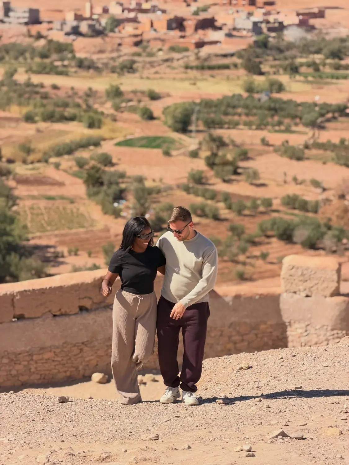 Walking a viewpoint over a green valley and village