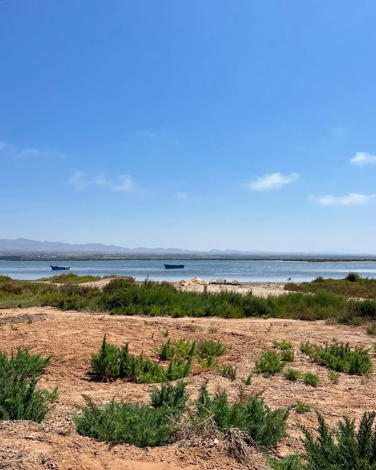 Two small boats moored on the calm Mar Chica lagoon at Nador