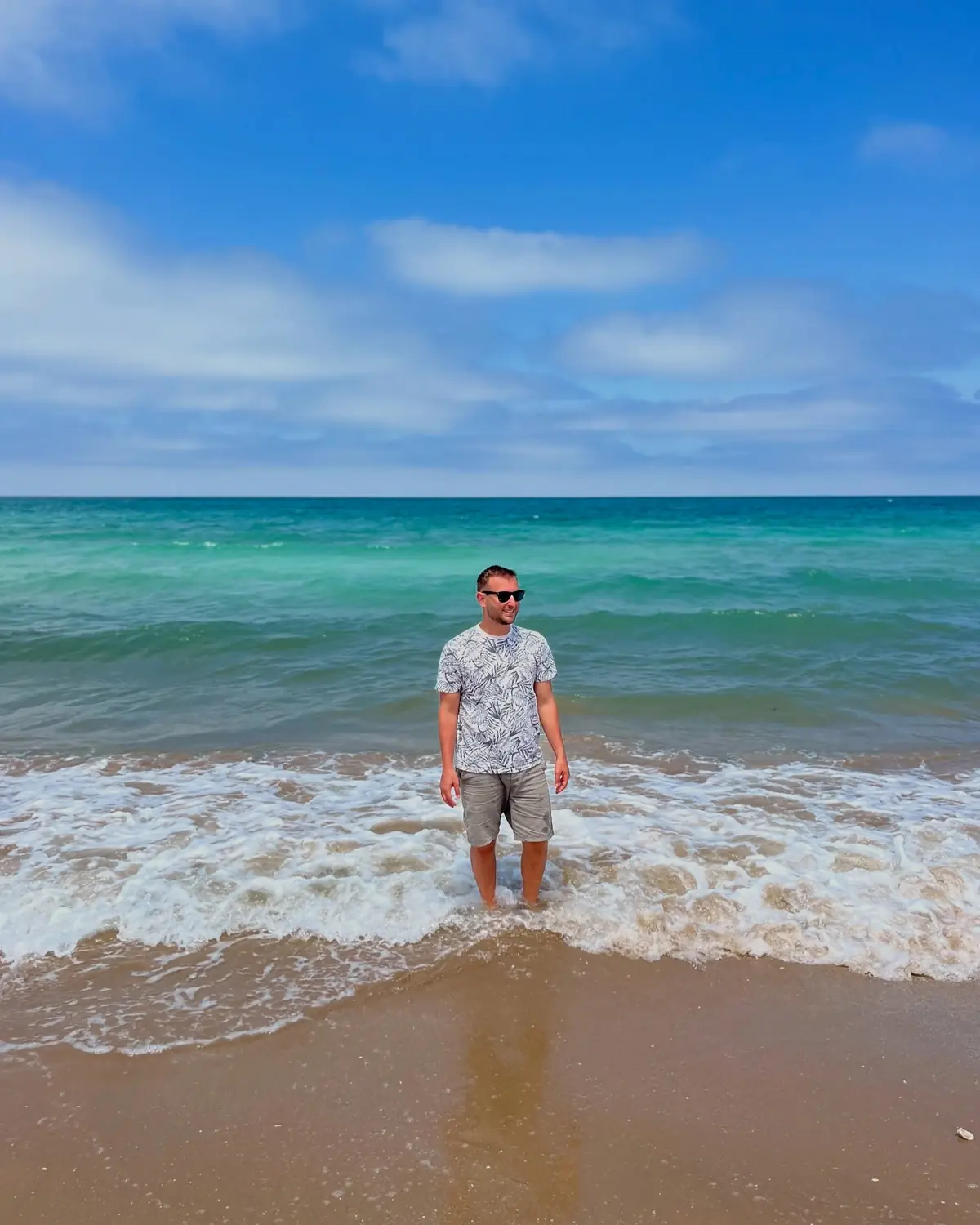 Andrew standing in the turquoise Mediterranean shallows off a Nador beach