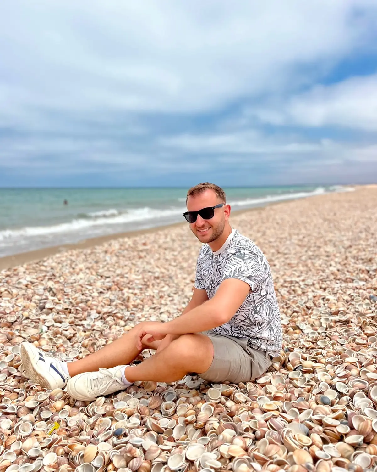 Andrew sitting on the shells at the water's edge in Nador