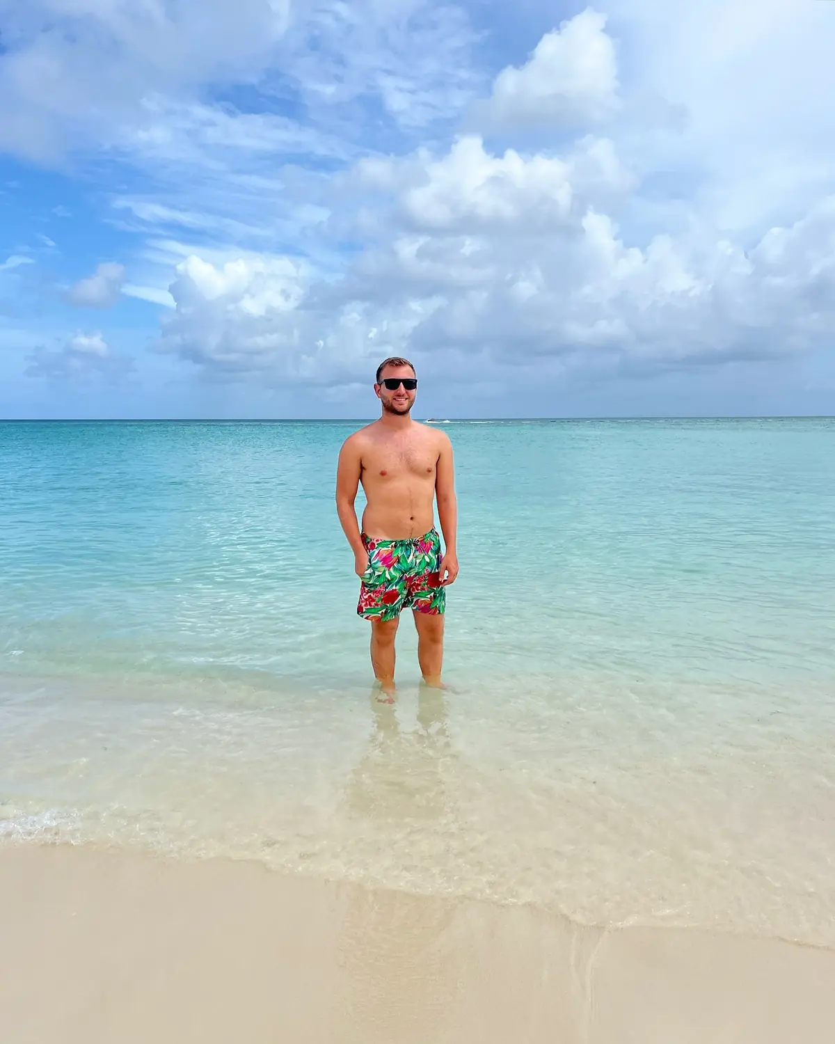 Andrew standing in shallow, perfectly clear Bahamas water under a bright sky
