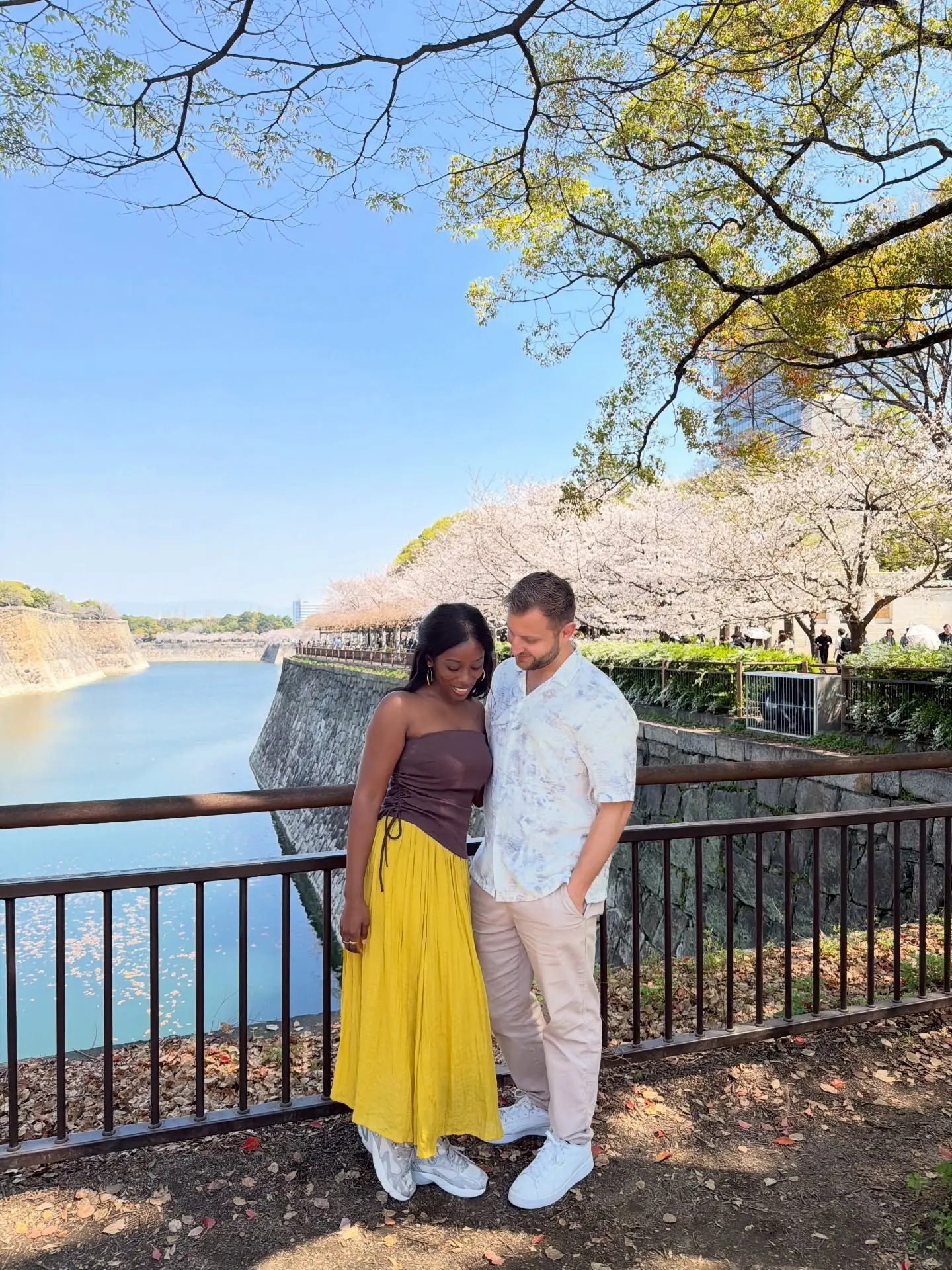 Us by the castle moat lined with cherry trees