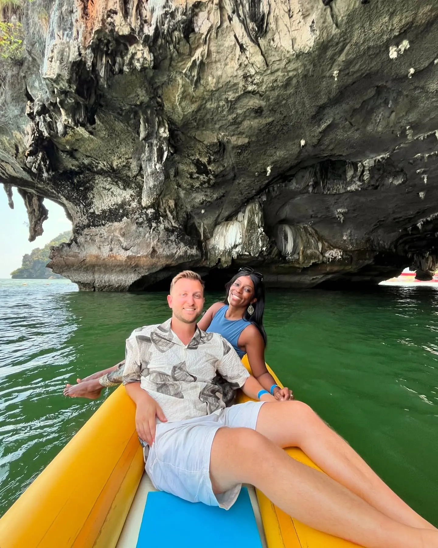 Sea-kayaking under a limestone cave arch in Phang Nga Bay