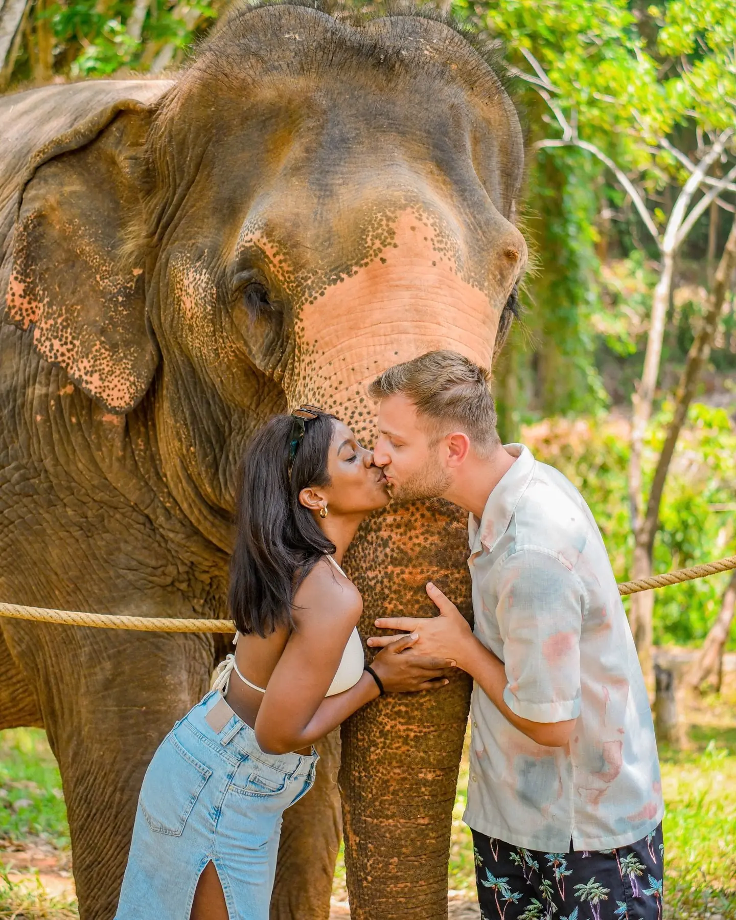 Us sharing a kiss beside a rescued elephant