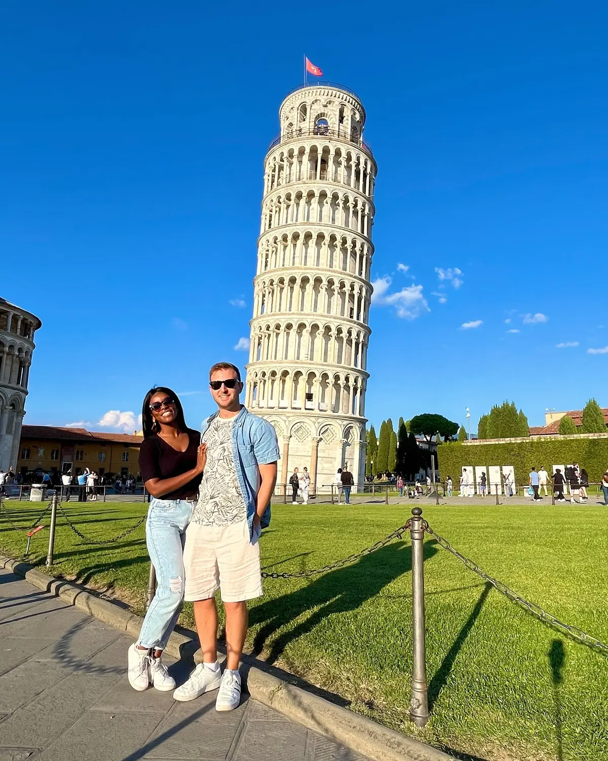 Us standing together in front of the Leaning Tower of Pisa