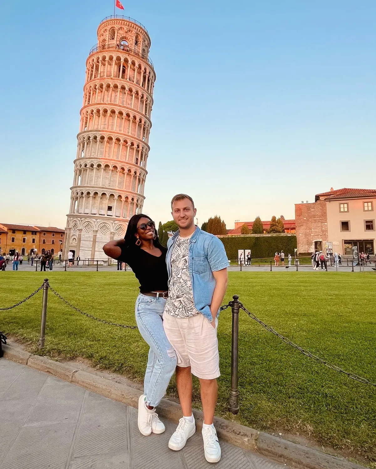 Us in front of the Leaning Tower bathed in golden-hour light