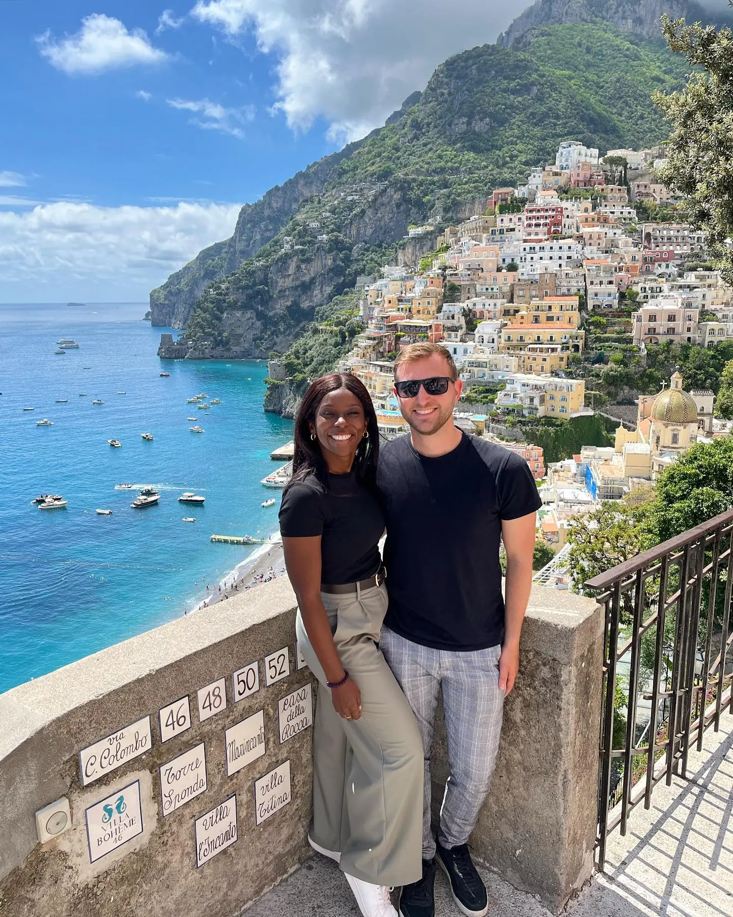 Us by the hand-painted Via Colombo street-name tiles above Positano's bay