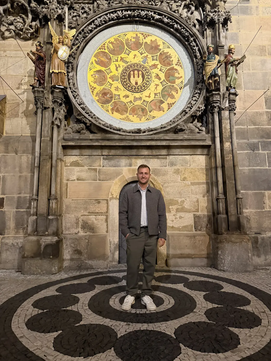 Andrew standing beneath the ornate dial of the Prague Astronomical Clock