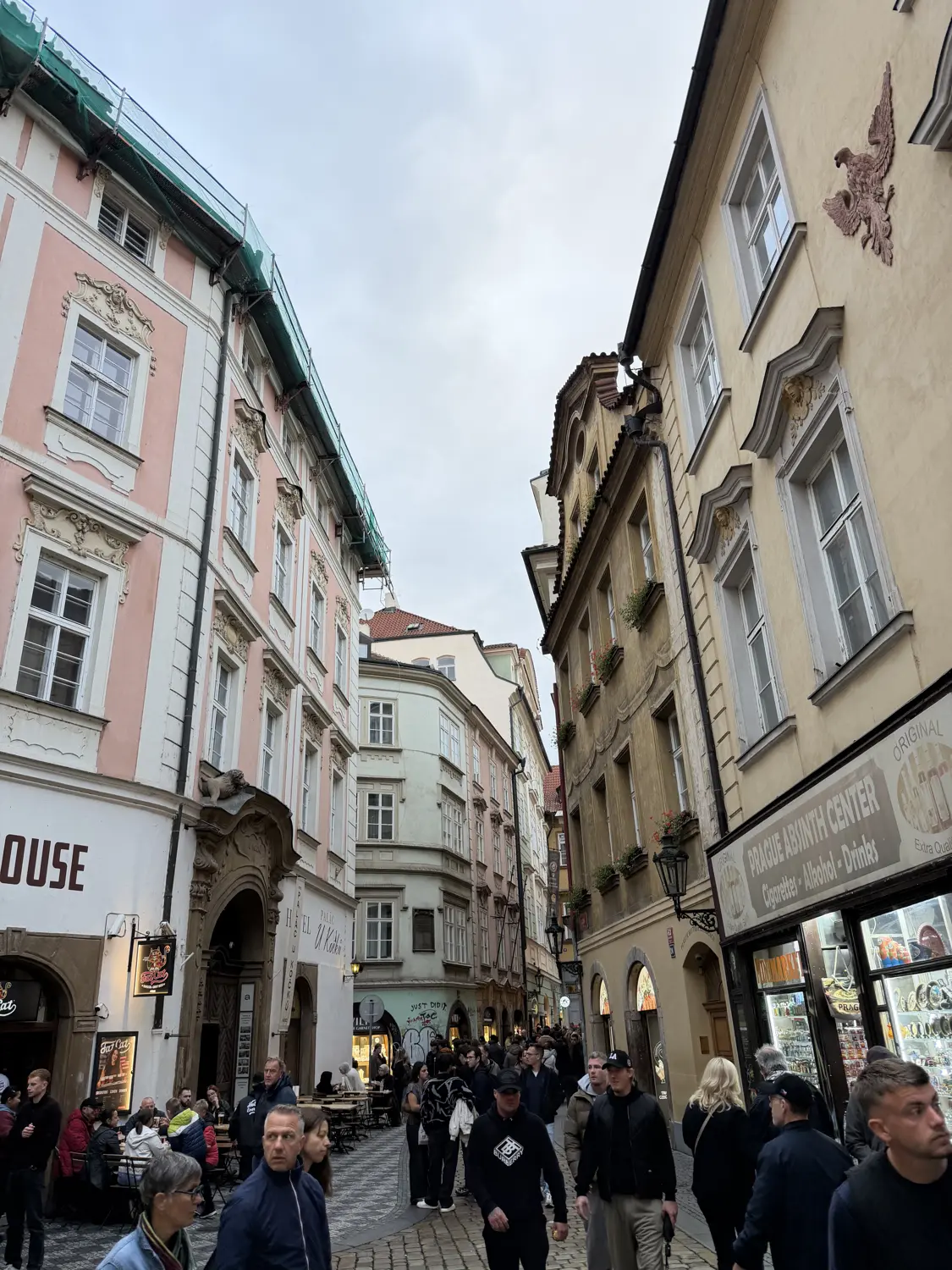 A busy cobbled street lined with pastel buildings in the Old Town