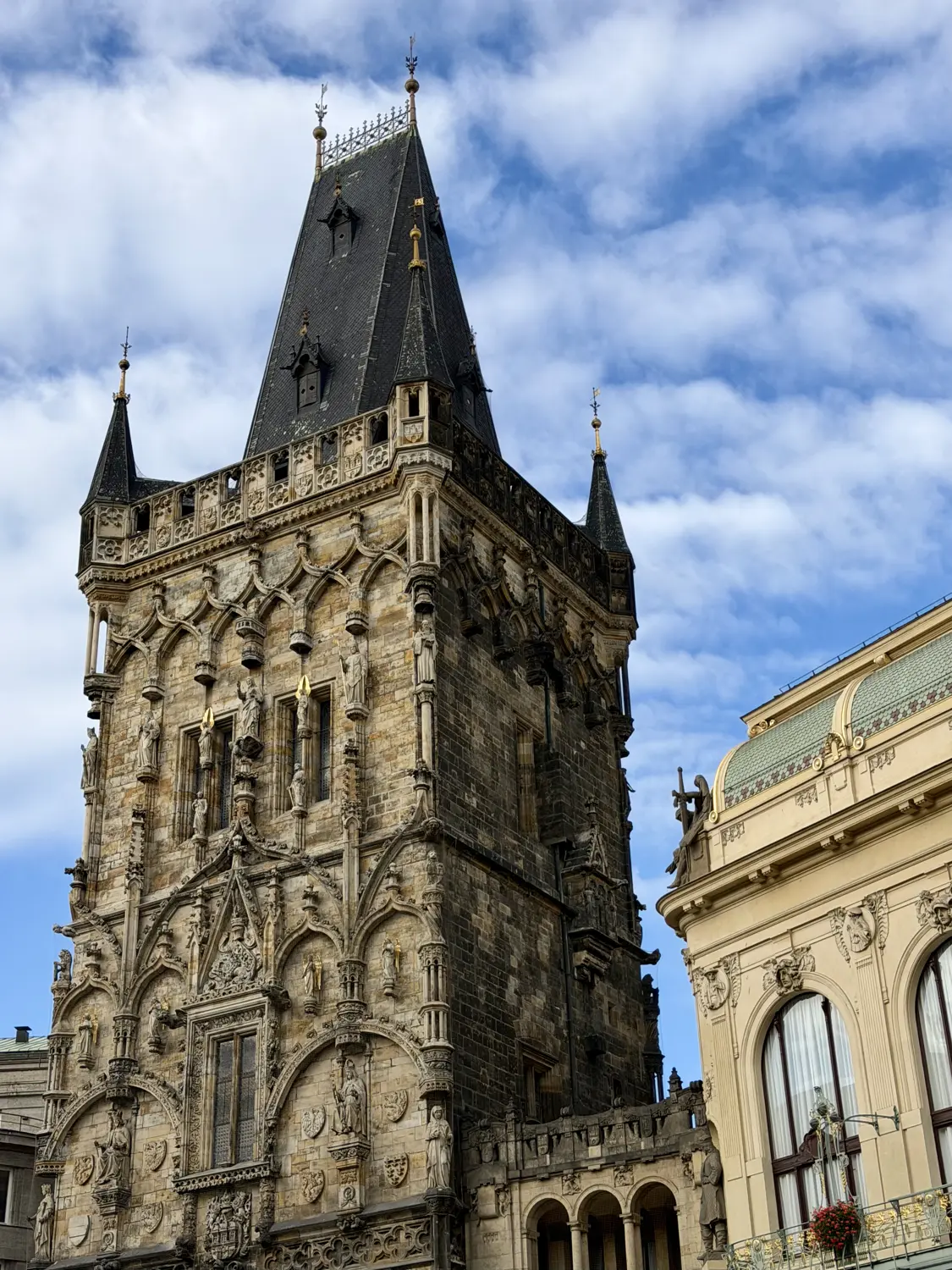 The dark Gothic Powder Tower against a blue sky