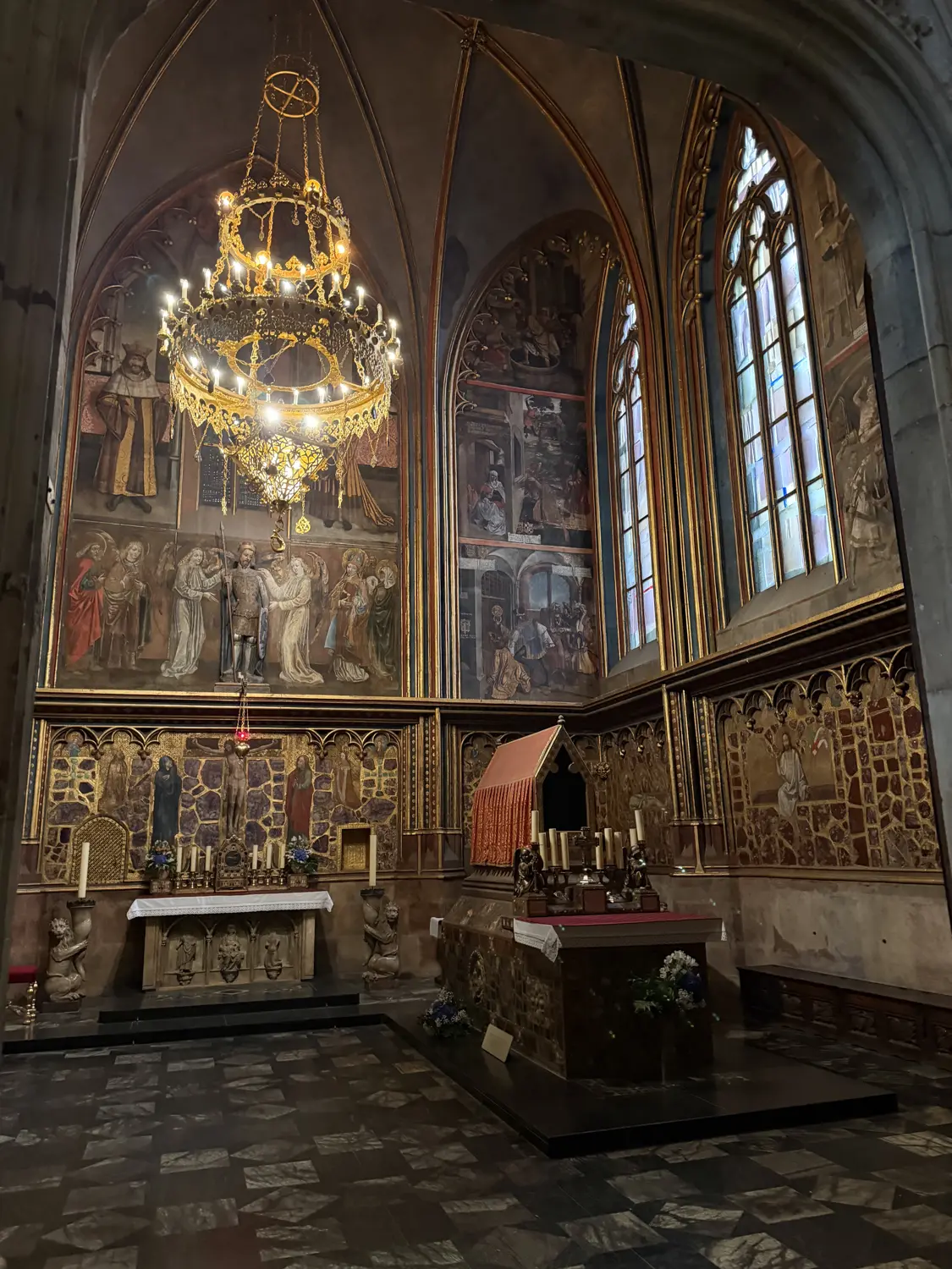 A richly decorated chapel with a chandelier inside St Vitus Cathedral