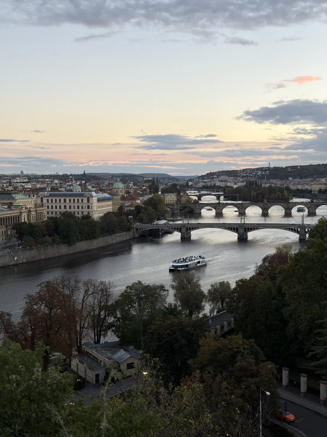 The bridges of the Vltava at dusk from a hilltop viewpoint