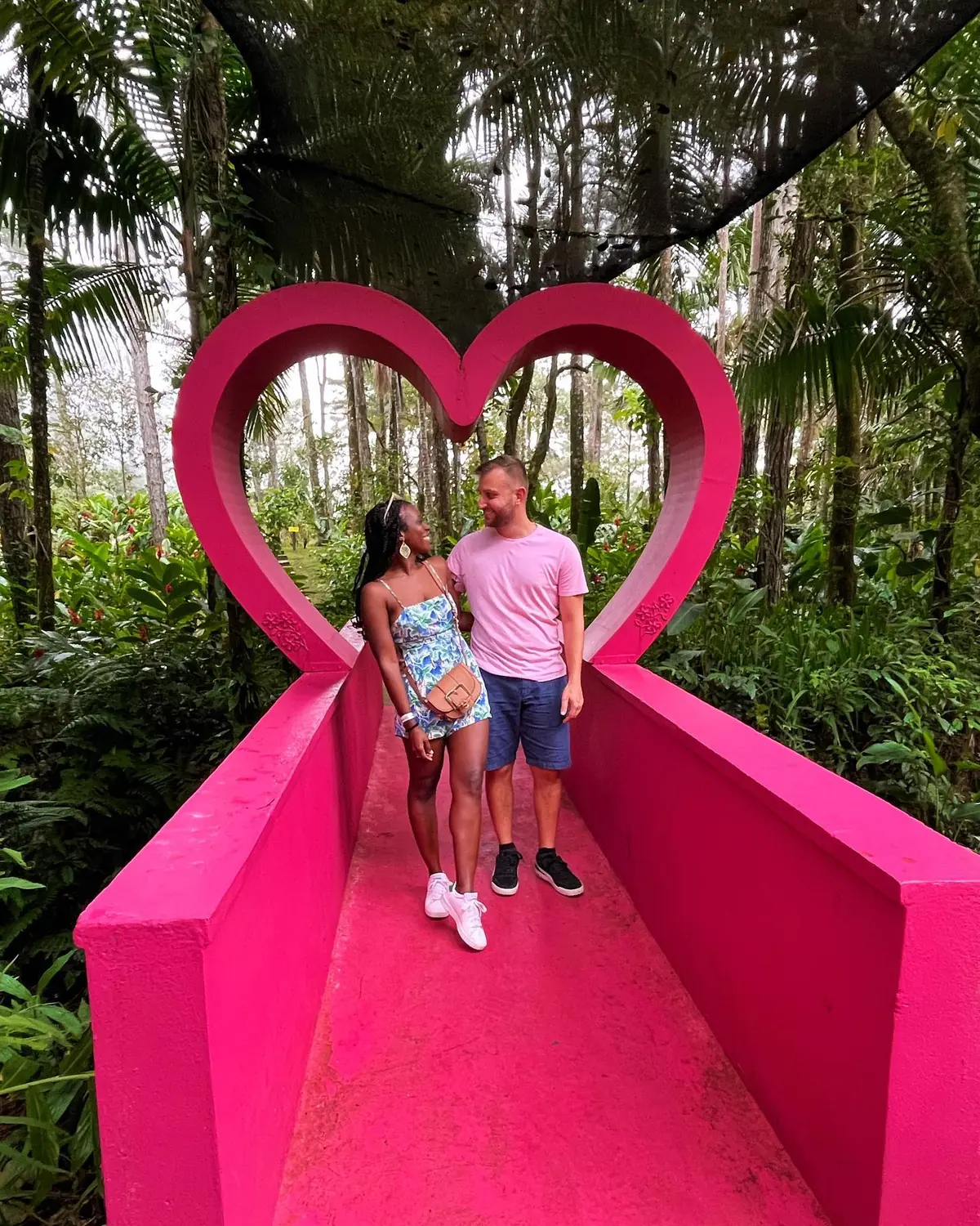 Us in a bright pink heart photo frame in the jungle park atop Pico Isabel de Torres, Puerto Plata