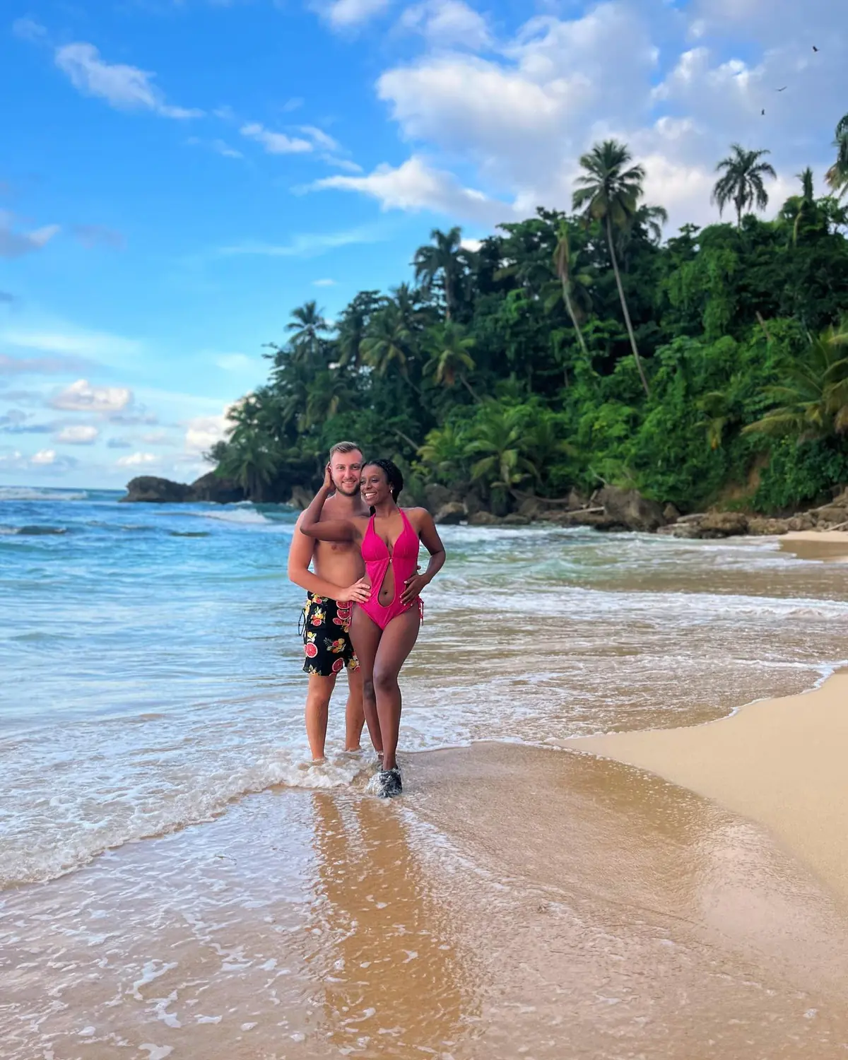 Us on a jungle-backed cove beach with waves rolling in, Samaná