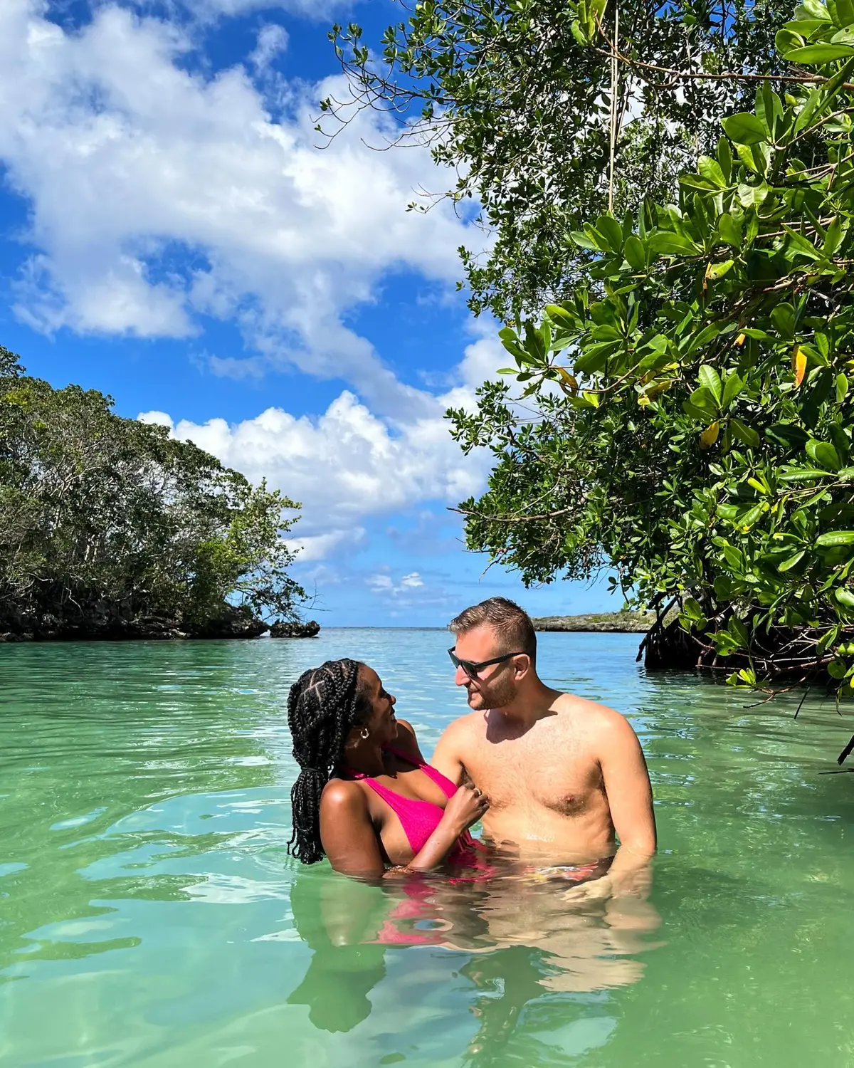 Us swimming together in clear green water among mangroves in Samaná
