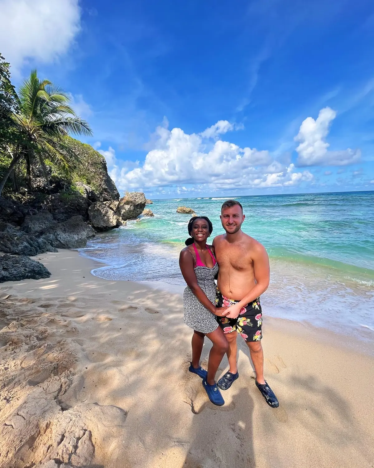 Us on a small rocky cove with a green cliff and turquoise water in Samaná
