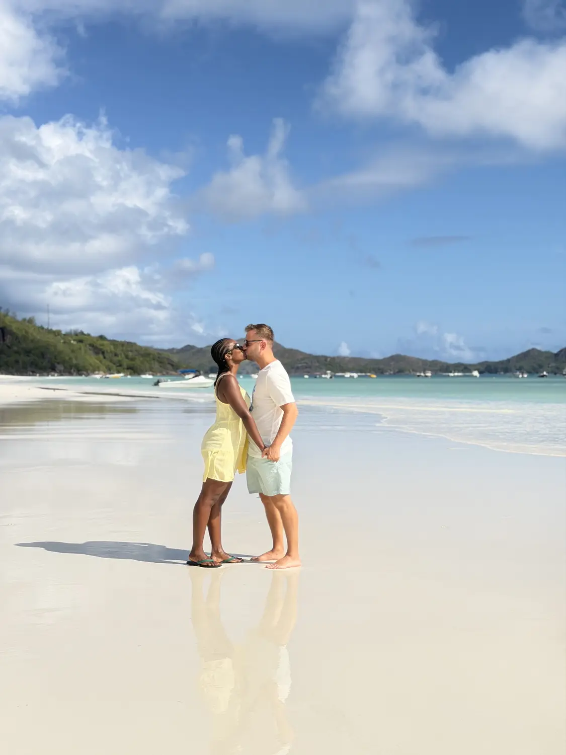 Us sharing a kiss on the mirror-like sand of Côte d'Or, Praslin
