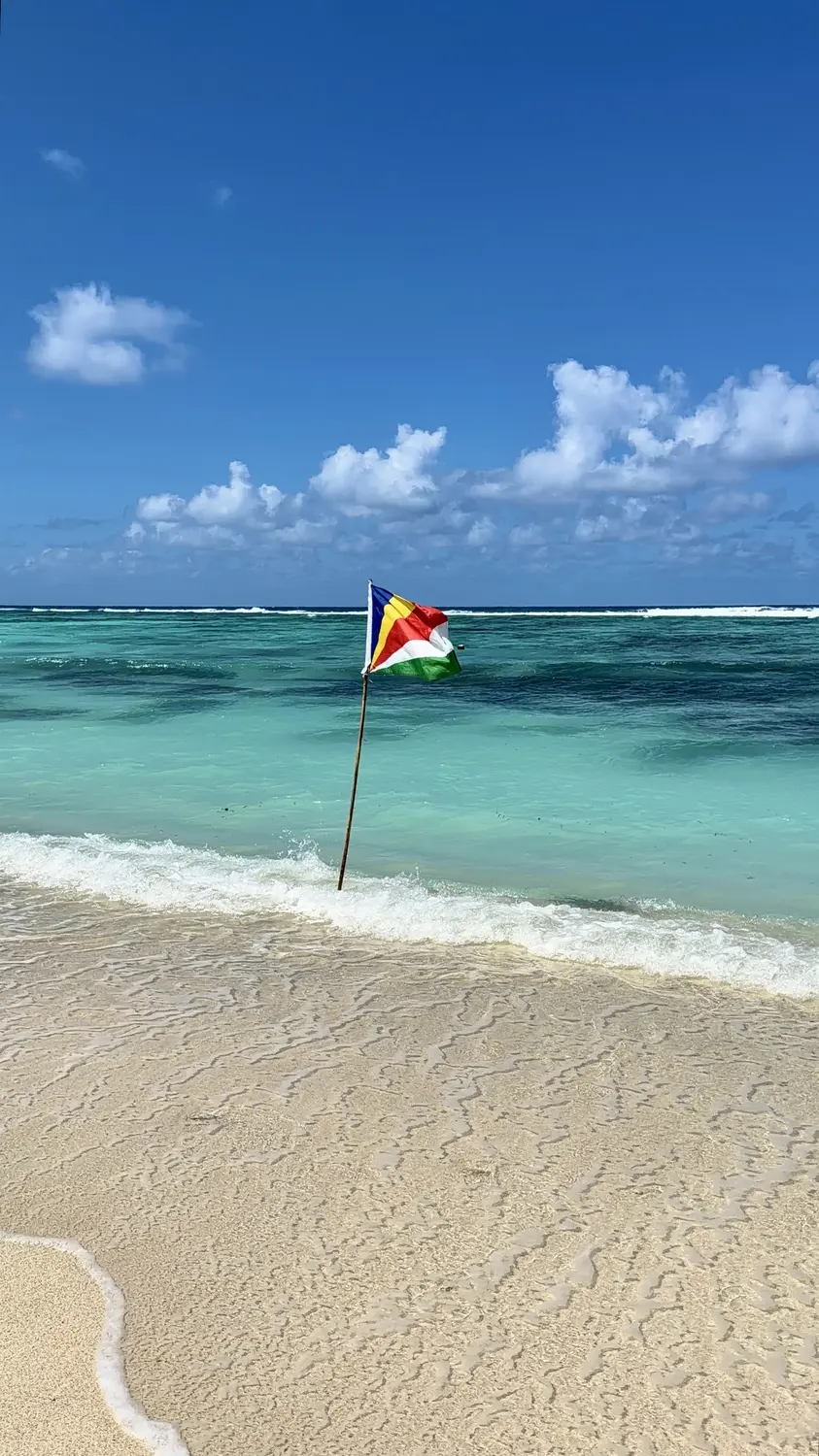 The Seychelles flag on a La Digue beach