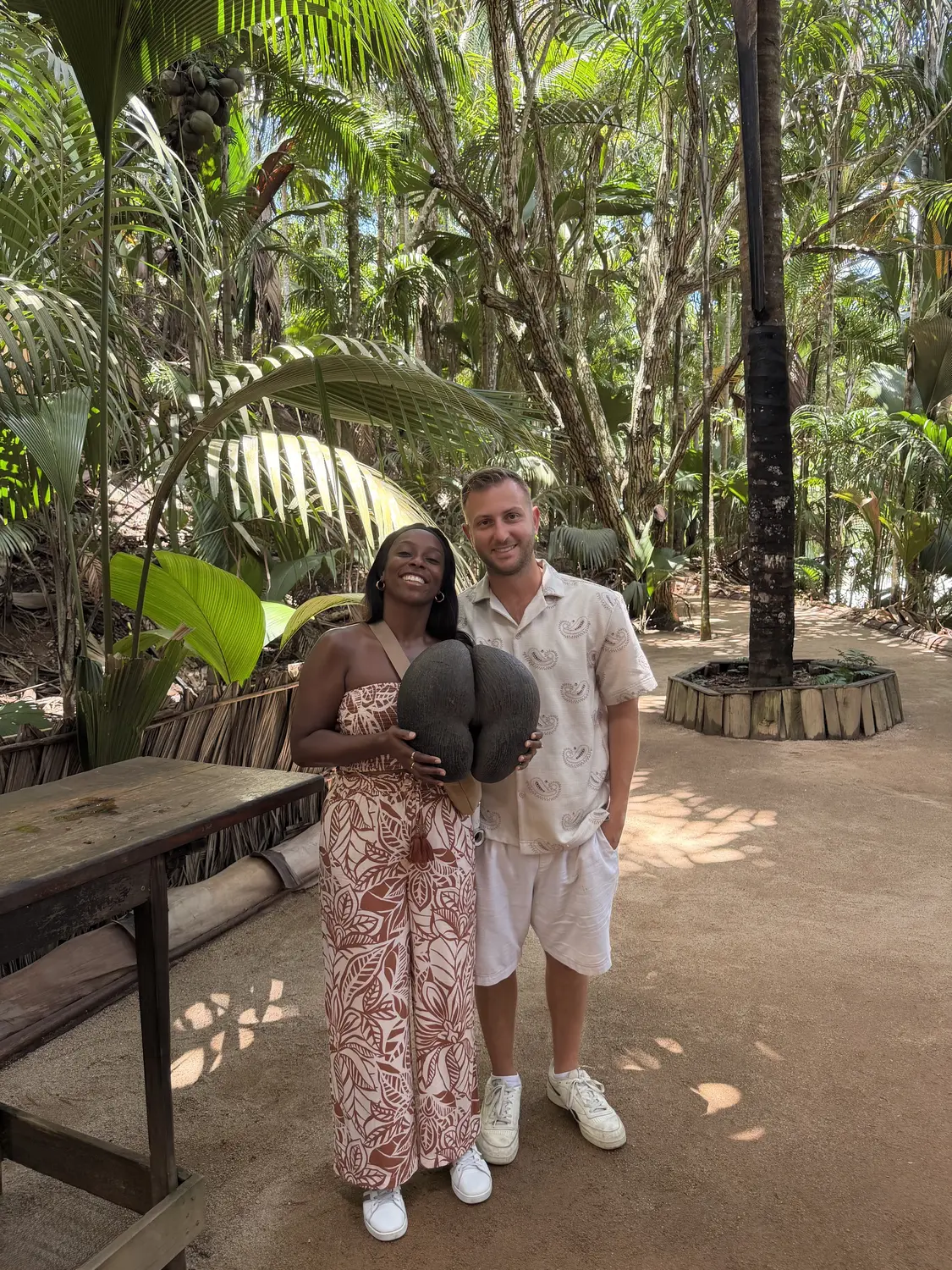 Us holding a giant double coco de mer seed in the palm forest of the Vallée de Mai, Praslin