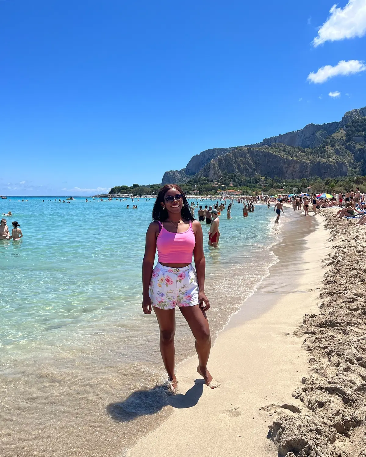Melody walking the shoreline of Mondello beach in the clear water