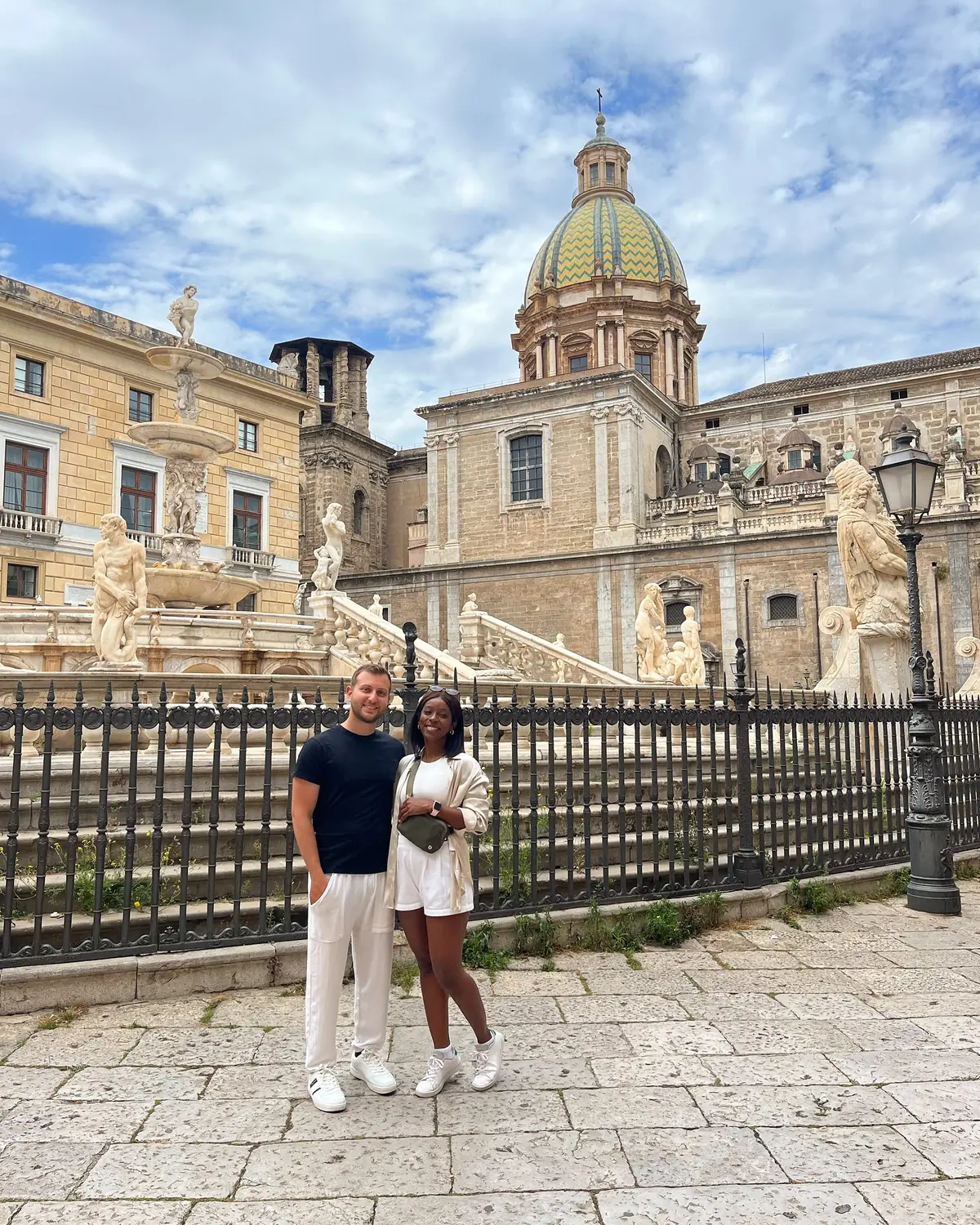 Us in front of the marble statues of the Pretoria Fountain in Palermo
