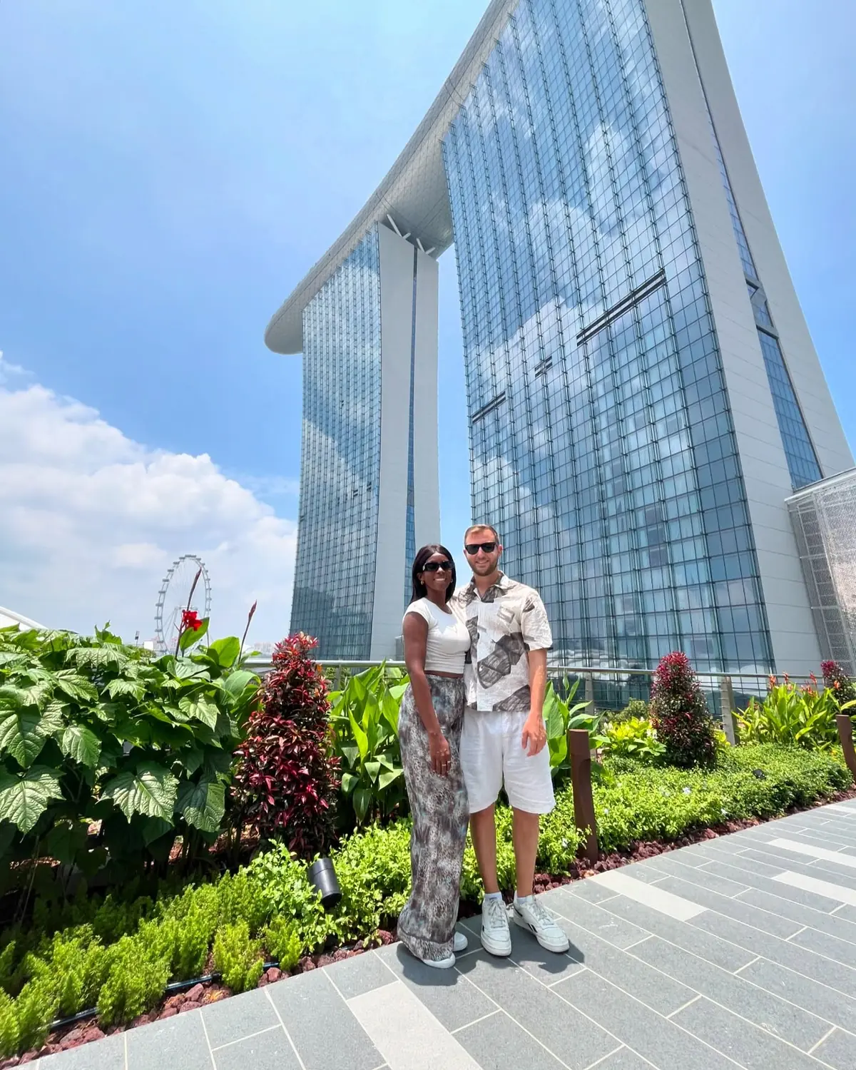 Us on a rooftop with the towers of Marina Bay Sands rising behind us in Singapore