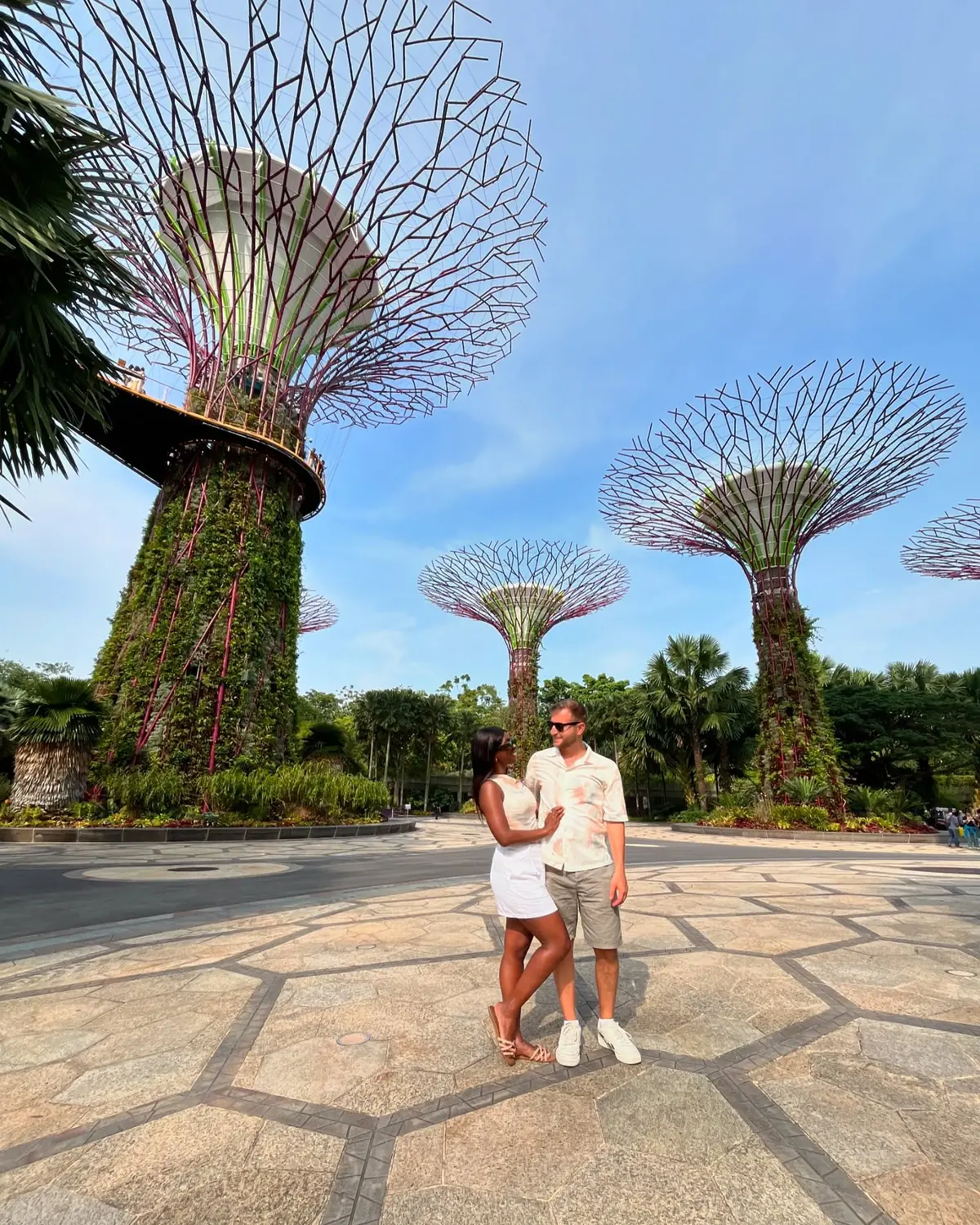 Us standing among the towering Supertrees at Gardens by the Bay
