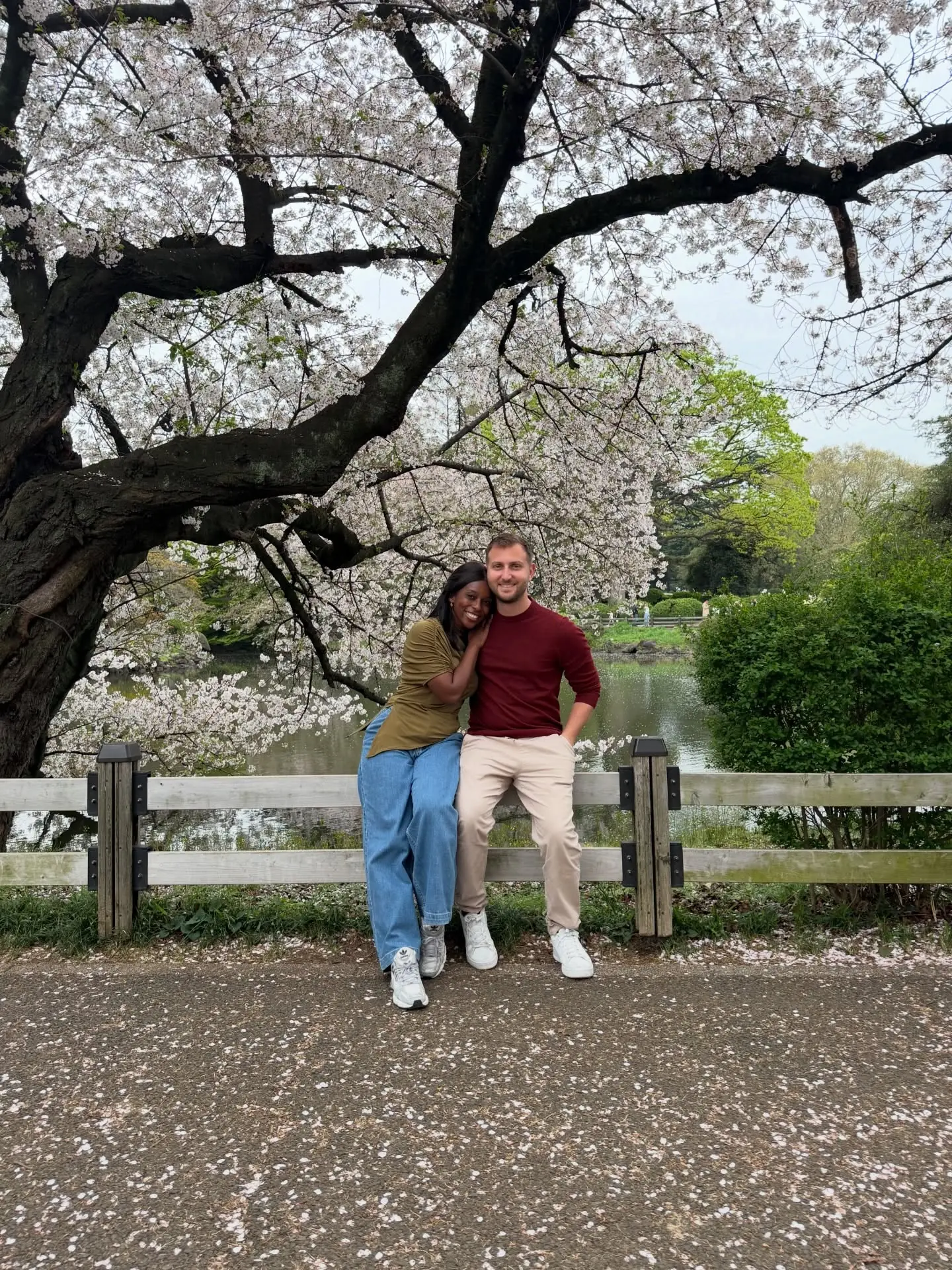 Us resting under a huge cherry tree by a pond in a Tokyo park