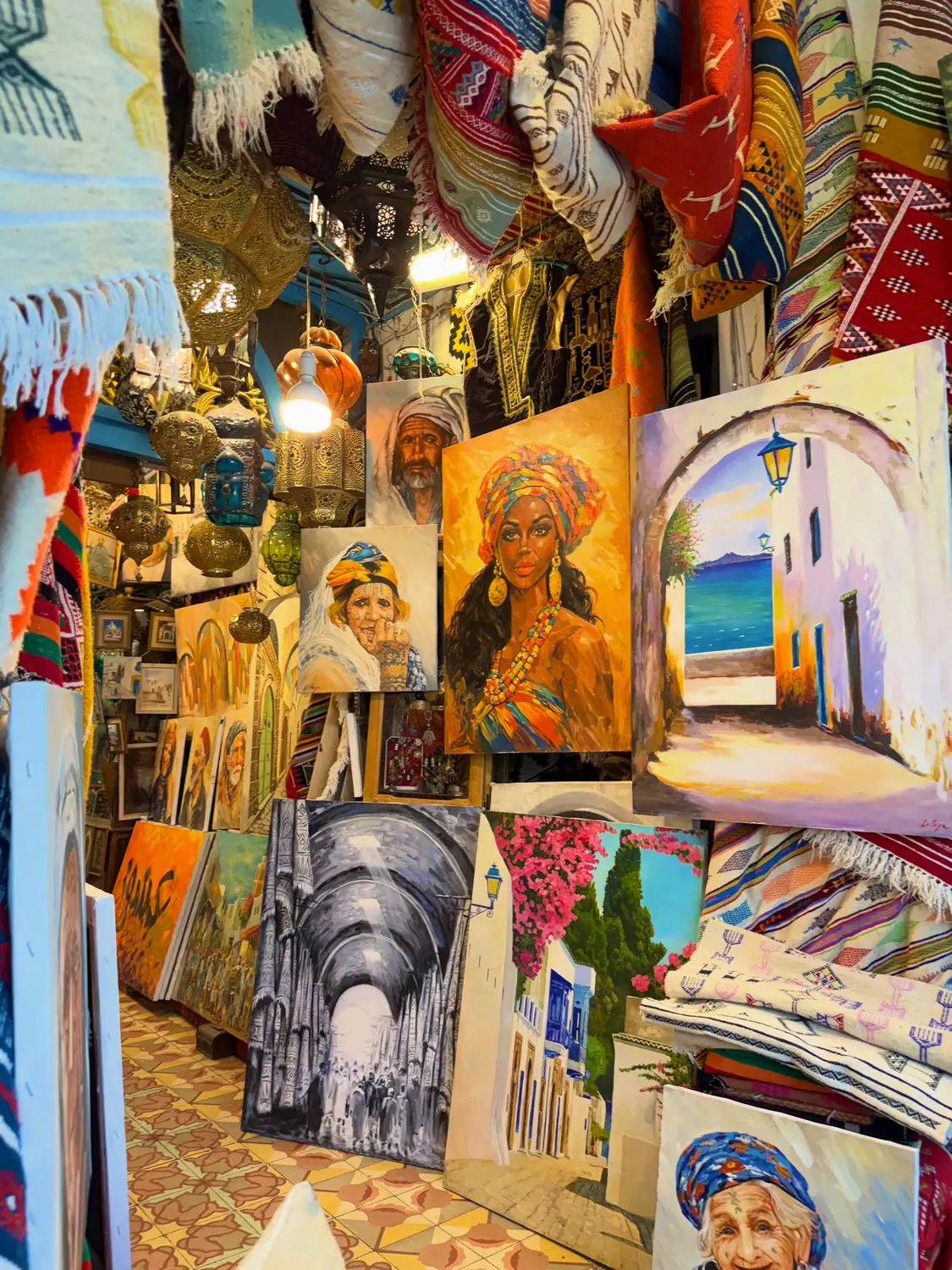 A Tunisian art and carpet shop crammed with paintings and lanterns