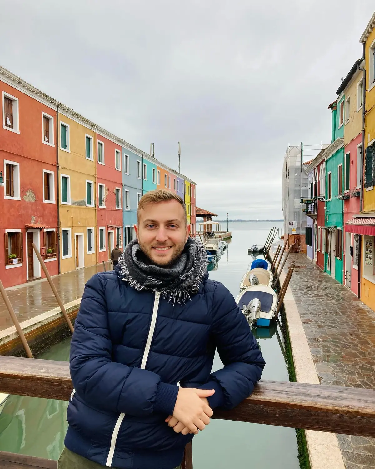 Andrew on a canal lined with brightly painted houses on Burano