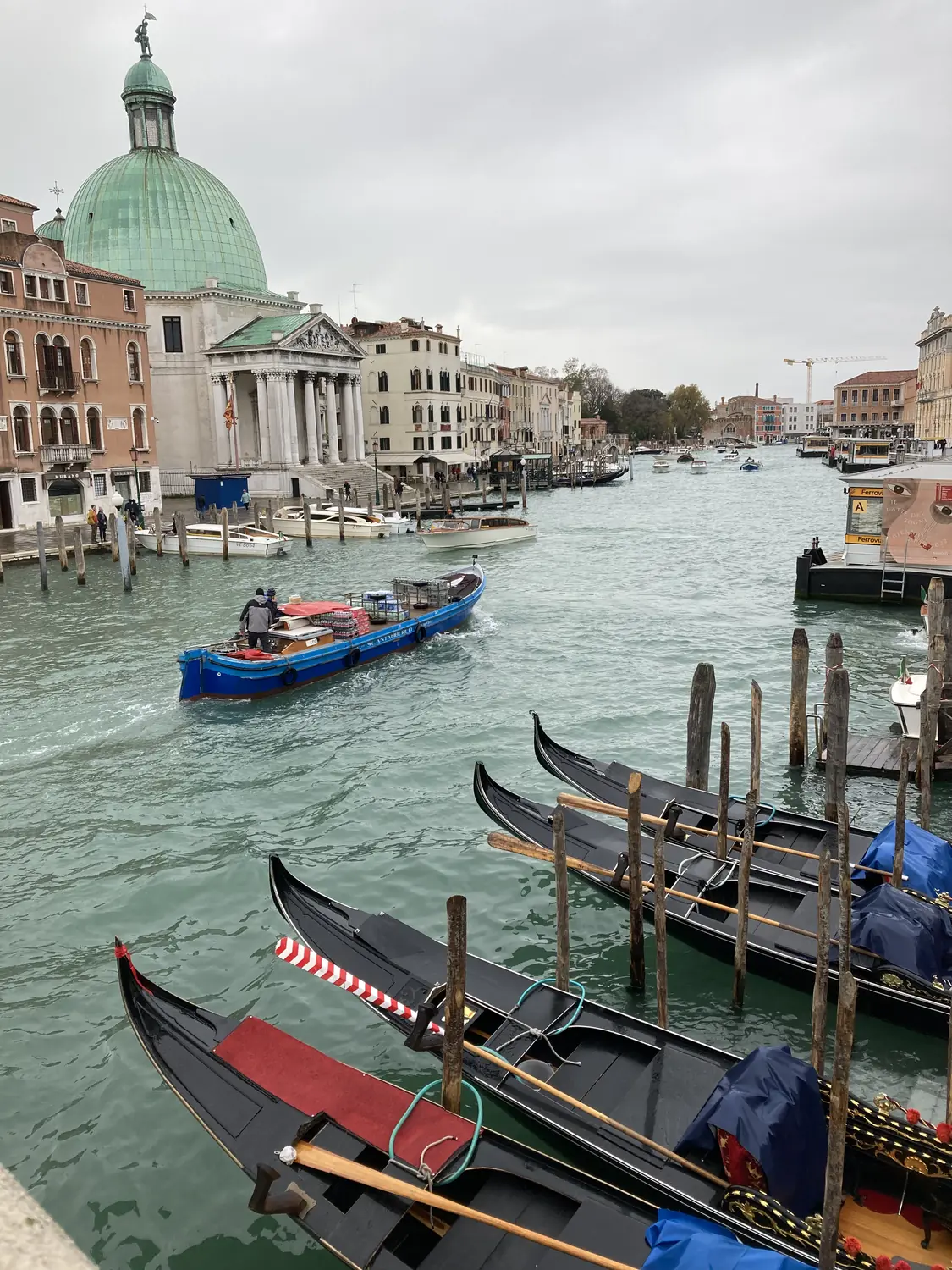 Gondolas on the Grand Canal with a domed church behind in Venice