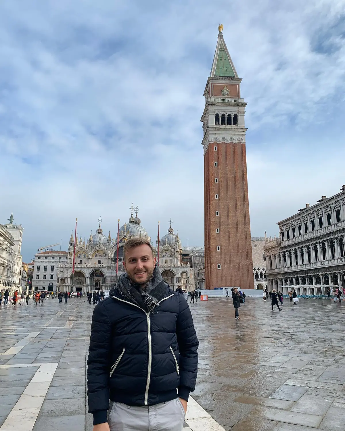 Andrew in St Mark's Square with the Campanile bell tower behind in Venice