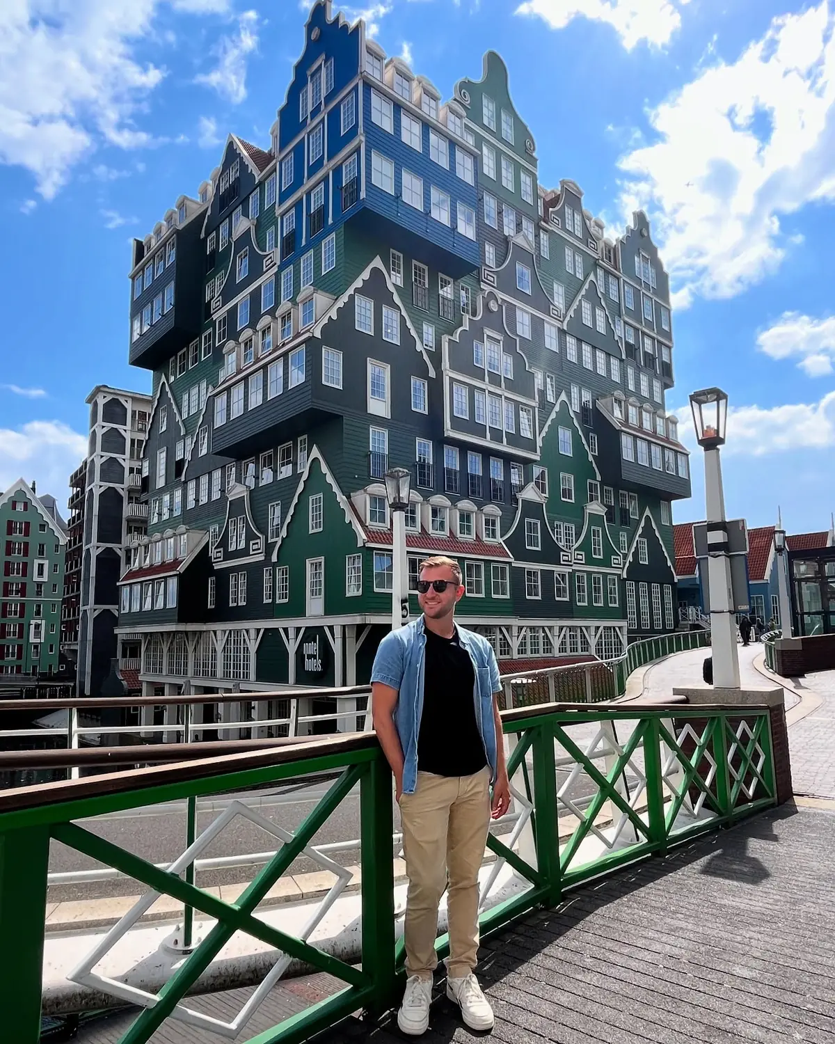 Andrew in front of the stacked green-house facade of the Inntel Hotel in Zaandam