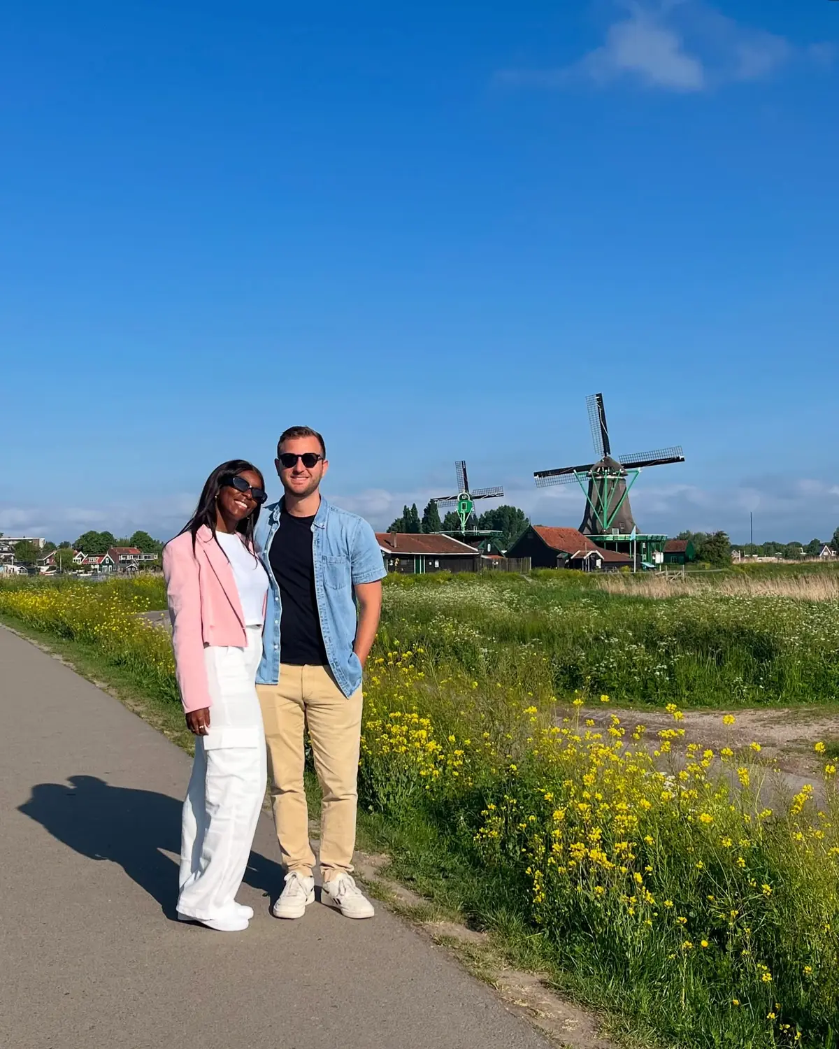 Us on a path with the working windmills of the Zaanse Schans behind us